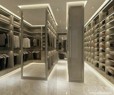 a walk in closet with mirrored walls and shelves