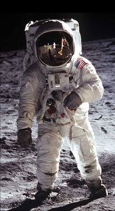 an astronaut standing on the moon with his hands in his pockets and looking up at the stars