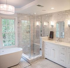 a large bathroom with a tub, sink and shower stall in it's corner