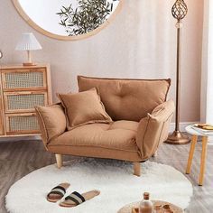 a living room filled with furniture and a round mirror on the wall over a white rug