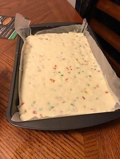 a pan filled with cake batter sitting on top of a wooden table