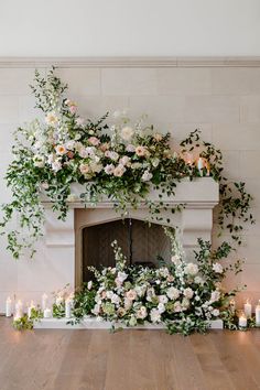 a fireplace decorated with flowers and candles