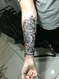 a woman's arm with a rose tattoo on it