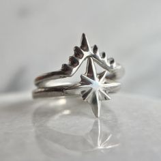 Stars and heavenly bodies have always been the tools used by humans for finding our way in the dark. Wear your very own little star to remind you that you know the way and to guide you! ✨  This perfectly nesting stacking ring set features a delicate North Star shape that stack with a V shaped band that almost looks like a little crown. Together they create a lovely celestial motif at your fingertips.  Wear these stacking rings together or swap them out to compliment other pieces in your collecti Heavenly Bodies, Galaxy Ring, Teardrop Ring, Stacking Ring Set, Synthetic Opal, Dark Wear, Star Ring, Timeless Jewelry, Opal Earrings