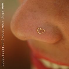 a woman's nose with a tiny heart on it