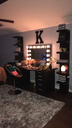 a bedroom with a vanity, mirror and lights on the wall above it's desk