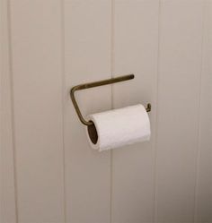 a roll of toilet paper is hanging on the wall