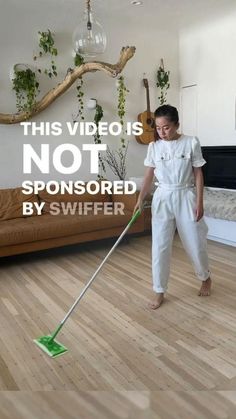 a woman with a mop is cleaning the floor