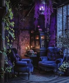 an old fashioned living room with purple lighting and blue chairs in front of the fireplace