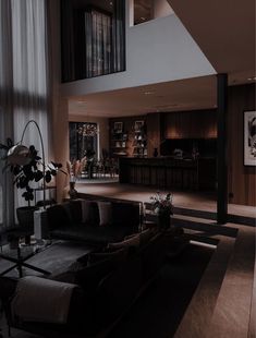 a living room filled with furniture and tall windows