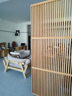 a living room filled with furniture and wooden slats