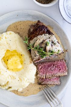 steak, mashed potatoes and gravy on a plate