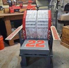 a chair made out of hockey sticks in a room with other items on the table