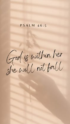 a hand holding a flower with the words god is within her she will not fall