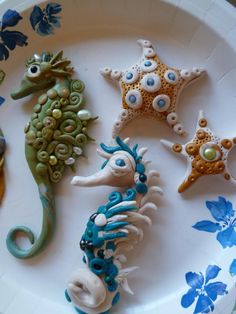 seahorses and starfish on a plate with blue flowers