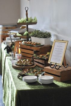 a table topped with lots of food next to a green table cloth covered flooring