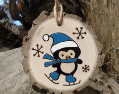 a wooden ornament with a penguin on it