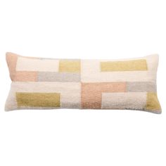 a rectangular pillow with multicolored squares on the front and back, sitting on a white background