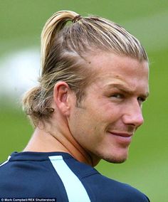 a man with blonde hair and a ponytail