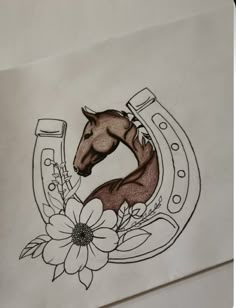 a drawing of a horse in a horseshoe with flowers on the side and a flower inside