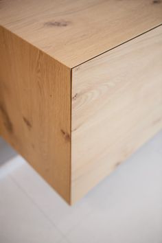 a close up of a wooden drawer on the floor