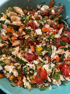 a blue bowl filled with lots of different types of food