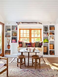 a living room filled with furniture and bookshelves