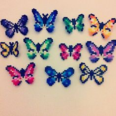 a group of colorful butterflies sitting on top of a white table