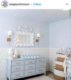 a baby's room is decorated in blue and white