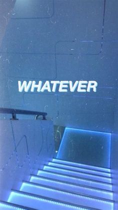 the word whatever is written on a glass door with steps leading up to it in blue light