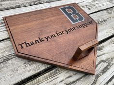 a wooden plaque with the words thank you for your support