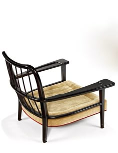 a wooden chair with a dog bed on it's back and footrests