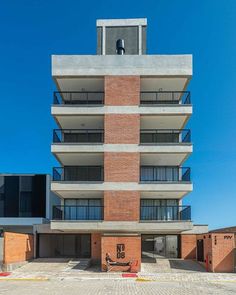 an apartment building with balconies on the second floor