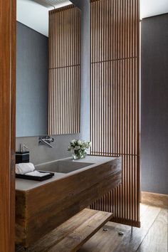 a bathroom with two sinks and wooden partitions