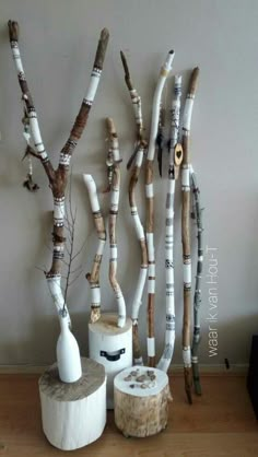 there are many branches made out of toilet paper rolls and vases on the floor