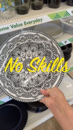 a person holding up a plate with no skills written on it in front of some plates