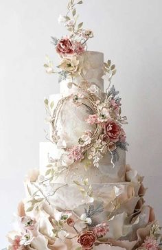 a three tiered wedding cake with flowers on it