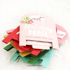 a pile of christmas mail sitting on top of snow covered ground