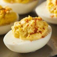 deviled eggs with mustard and seasoning on them