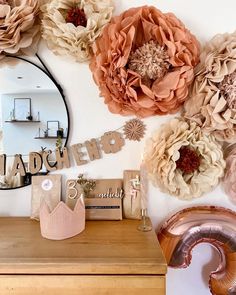 there are many large flowers on the wall next to this dresser and mirror that says happy birthday