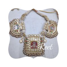 the necklace is adorned with pearls and stones, which are decorated with an image of jesus