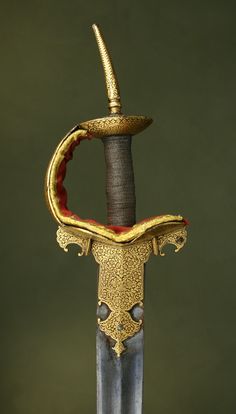 Indian Firangi     Dated: 18th Century  Measurements: the blade is 34.75 inches long  This sword was most likely made for Royalty. It has a thick gold koftgari floral decoration over the entire hilt. Comes with an unmarked blade. The padding was replaced during the mid-late 19th century.    It has a wired grip of silver and senew mixture. Nizam Of Hyderabad, Shivaji Maharaj Painting, Alwar Rajasthan, Maharaj Wallpapers, Mahadev Hd Wallpaper, Shivaji Maharaj Hd Wallpaper, Hd Wallpaper Android, Shiva Wallpaper, Shiva Art