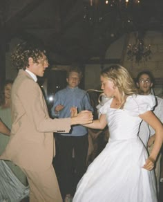 a man and woman dancing at a wedding