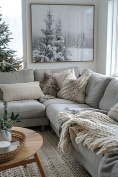 a living room filled with furniture and a christmas tree in the window sill next to a couch