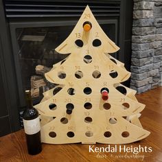 a wooden christmas tree with wine bottles in it and a bottle opener on the side