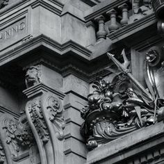 a black and white photo of the front of a building with ornate carvings on it