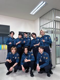 a group of young men in uniform posing for a photo together, with one pointing at the camera