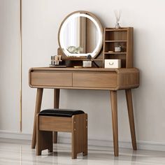 a wooden dressing table with a mirror and stool in front of it on the floor