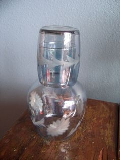 a clear glass vase sitting on top of a wooden table