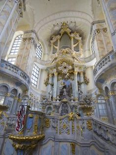 the inside of a church with gold and white decorations